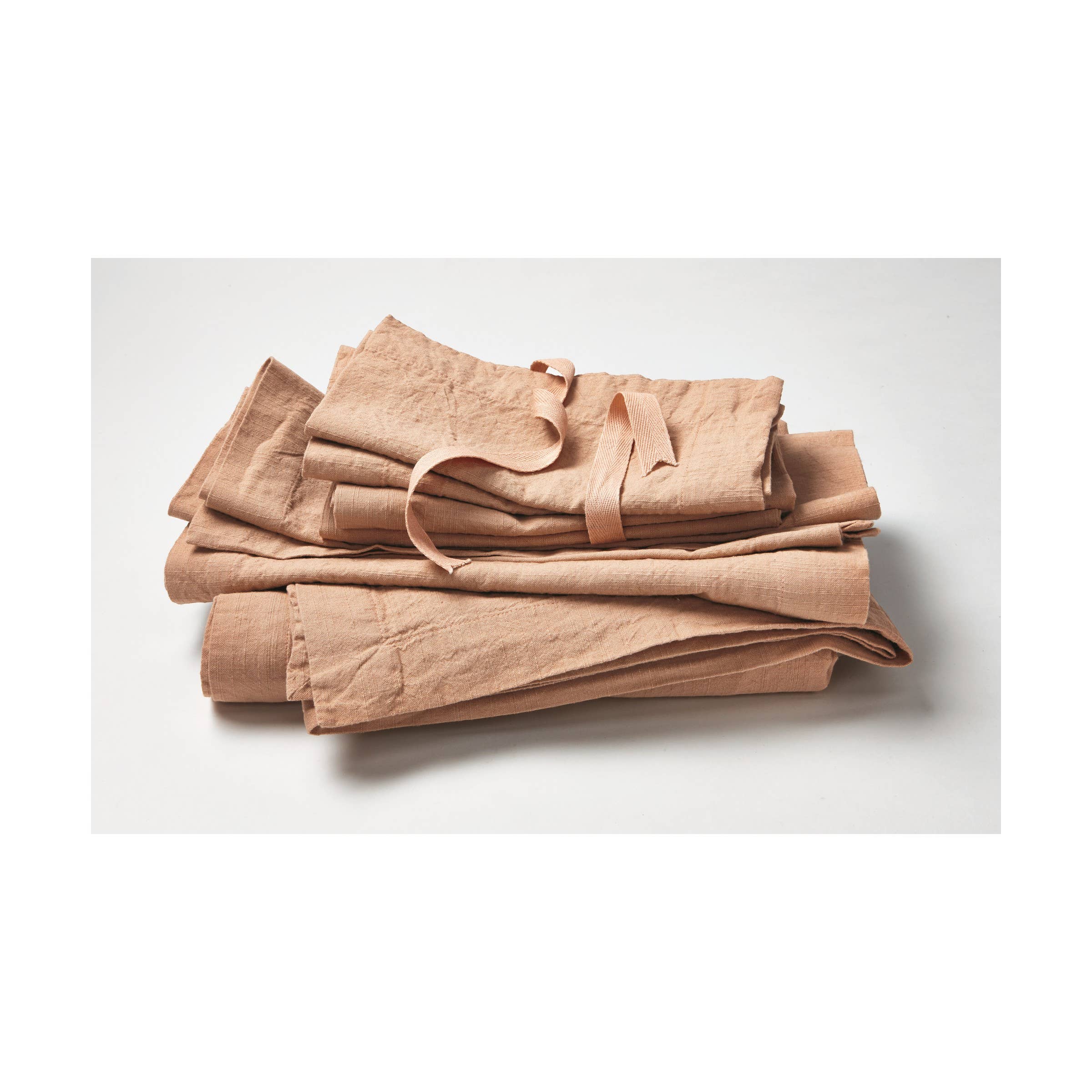 Blush pink cotton napkin with woven slub texture, 20-inch square