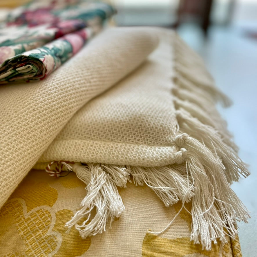 pine cone hill dove white twin blanket made of 100 percent cotton cream color with visible weave texture and fringe edge 50 by 70 inches from annie selke