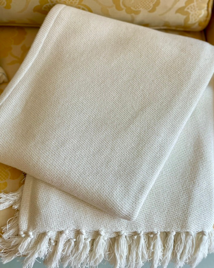 pine cone hill dove white twin blanket made of 100 percent cotton cream color with visible weave texture and fringe edge 50 by 70 inches from annie selke