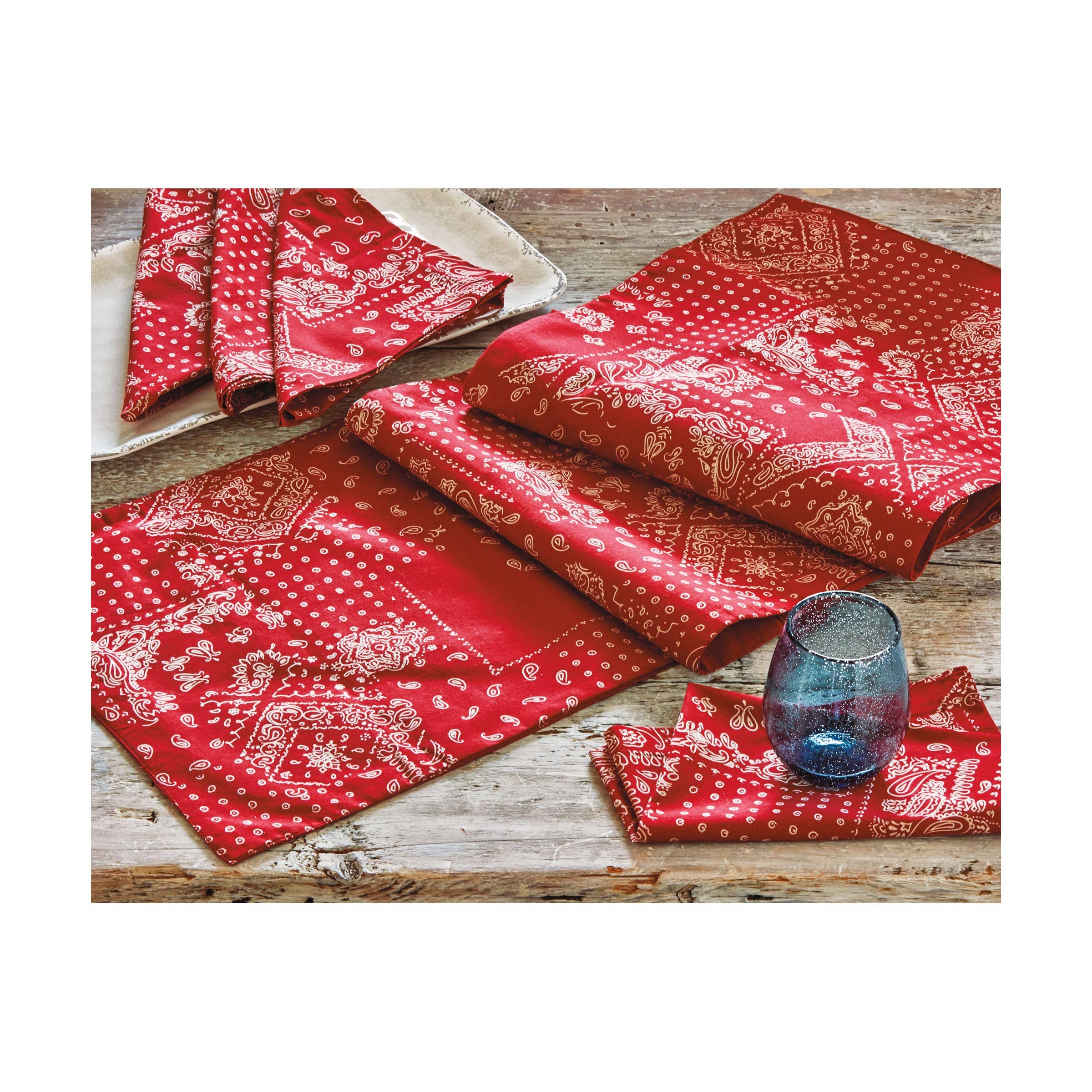 Set of four red cotton napkins with classic white bandana print, tied with matching ribbon