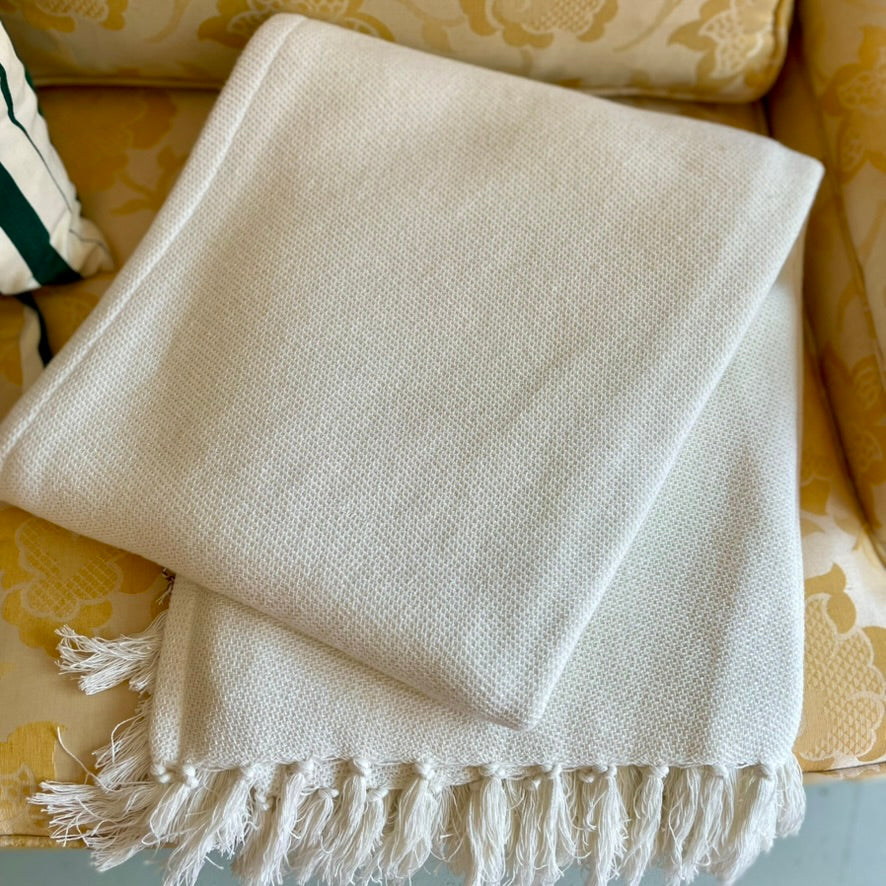 pine cone hill dove white twin blanket made of 100 percent cotton cream color with visible weave texture and fringe edge 50 by 70 inches from annie selke