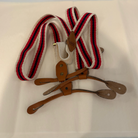 Striped suspenders with leather straps on a white background