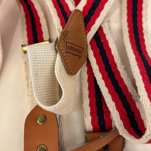 Close-up of suspenders with a Levi's logo on a white background