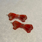 western red barrette with gold details like a bandana