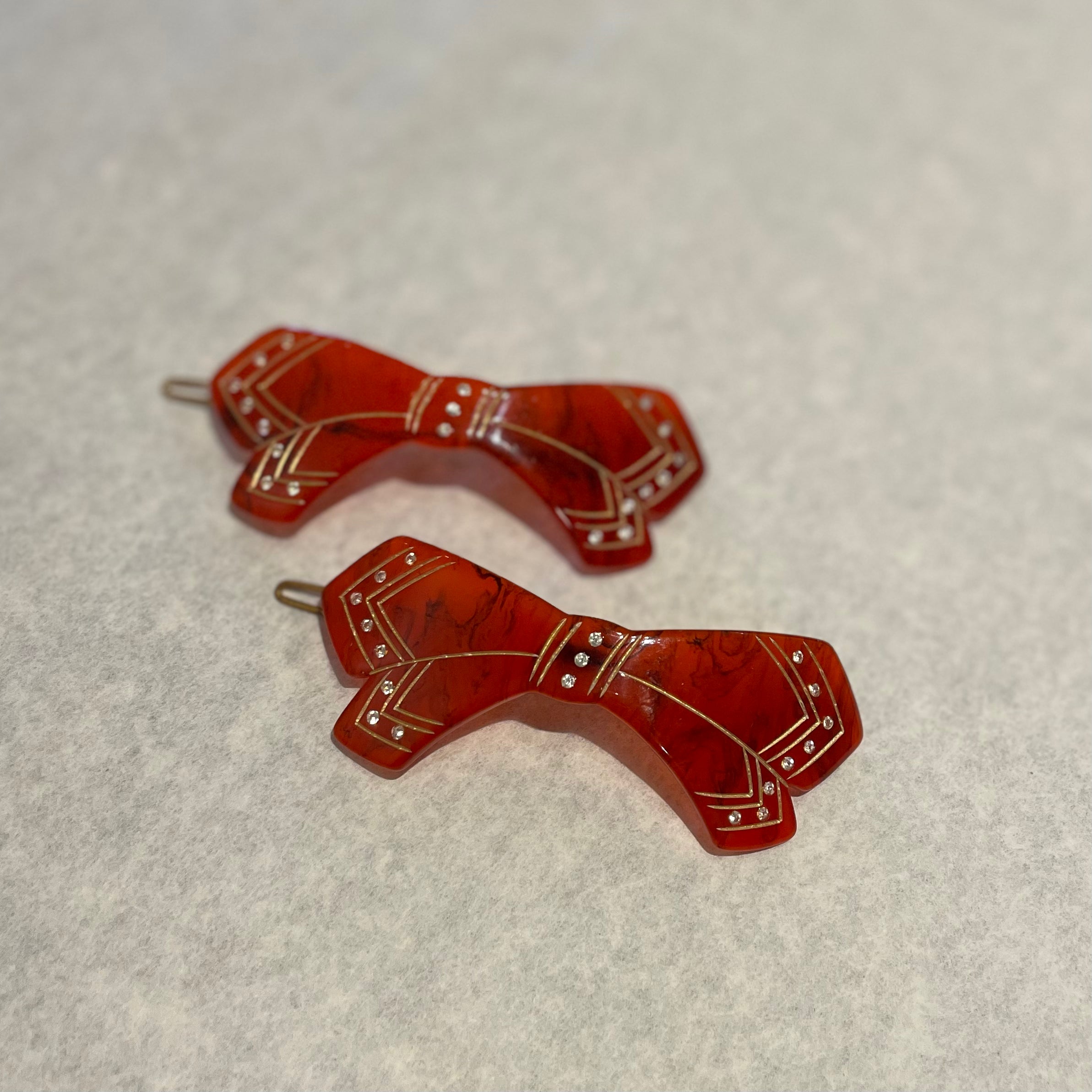 western red barrette with gold details like a bandana