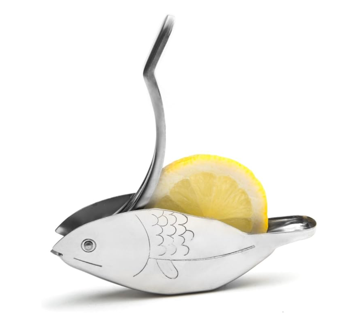 Stainless steel lemon squeezer in the shape of a fish with etched scale details